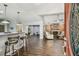 Bright living space with a fireplace, modern bar seating, and wood-look floors with an open concept design at 7004 Westminster St, Tampa, FL 33635