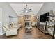 Cozy living room with brick fireplace, ceiling fan, neutral walls and stylish furnishings at 7004 Westminster St, Tampa, FL 33635