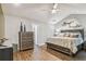 Spacious main bedroom with hardwood floors, complemented by modern decor, enhancing the comfortable ambiance at 7004 Westminster St, Tampa, FL 33635