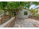 Expansive wooden back deck surrounded by a lush mango tree offers a relaxing outdoor space at 7208 S Juanita St, Tampa, FL 33616