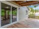 Inviting covered back porch with wood flooring that offers an ideal space for outdoor entertaining at 7208 S Juanita St, Tampa, FL 33616