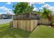 Grassy back yard with a raised wooden deck and privacy fence at 7208 S Juanita St, Tampa, FL 33616