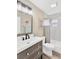 Neutral bathroom with updated vanity, a shower-tub combo and modern fixtures at 7208 S Juanita St, Tampa, FL 33616