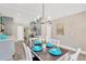 Open-concept dining area with modern lighting fixture and view into the kitchen at 7208 S Juanita St, Tampa, FL 33616