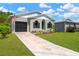 Charming home showcasing a well-manicured lawn, a convenient driveway, and a cozy one-car garage at 7208 S Juanita St, Tampa, FL 33616
