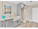 Bright kitchen featuring modern fixtures, an apron sink, and stylish wood-look flooring at 7208 S Juanita St, Tampa, FL 33616