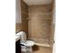 Bathroom featuring tiled shower, tiled accent wall and mosaic shower floor at 7601 W Deleon Ct, Tampa, FL 33615