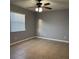 Neutral toned bedroom with tile flooring, ceiling fan, and window with blinds at 7601 W Deleon Ct, Tampa, FL 33615