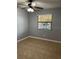 Bedroom featuring a ceiling fan, window with blinds, and tile flooring at 7601 W Deleon Ct, Tampa, FL 33615