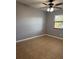Spacious bedroom featuring tile flooring, ceiling fan, and a large window at 7601 W Deleon Ct, Tampa, FL 33615
