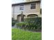Inviting two-story home with well-maintained landscaping, arched entryway, and classic architectural details at 7601 W Deleon Ct, Tampa, FL 33615
