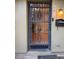 Inviting front door with secure iron gate, ample natural light, and easy access to the home's interior at 7601 W Deleon Ct, Tampa, FL 33615
