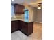 Updated kitchen with granite countertops, wood cabinets, tile flooring, and modern appliances for efficient cooking at 7601 W Deleon Ct, Tampa, FL 33615
