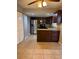 Open layout kitchen with stainless steel appliances, tile flooring and eat-in bar at 7601 W Deleon Ct, Tampa, FL 33615