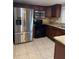 Updated kitchen featuring stainless steel appliances, wooden cabinets, granite countertops at 7601 W Deleon Ct, Tampa, FL 33615