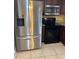 Stainless steel fridge and black oven complement the kitchen's functionality and style at 7601 W Deleon Ct, Tampa, FL 33615