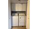 Enclosed laundry room with washer, dryer, and overhead storage at 7601 W Deleon Ct, Tampa, FL 33615
