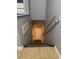 Carpeted stairwell leading to a door, handrails on the right wall, and light sconces on the left wall at 7601 W Deleon Ct, Tampa, FL 33615