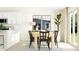 Well-designed dining room with a light wood table, black chairs, and modern decor at 7742 Painted Sky Pl, Land O Lakes, FL 34637