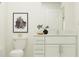 Bright bathroom featuring a white vanity with granite countertop, modern fixtures, and neutral decor at 7754 Painted Sky Pl, Land O Lakes, FL 34637