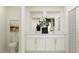 Elegant bathroom with a double sink vanity, quartz countertop, and a decorative mirror at 7754 Painted Sky Pl, Land O Lakes, FL 34637