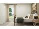 Bright and airy bedroom features a large window with backyard views and a comfortable bed at 7754 Painted Sky Pl, Land O Lakes, FL 34637