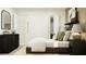Bedroom featuring a stylish dresser, a comfortable bed, a walk-in closet, and tasteful decor at 7754 Painted Sky Pl, Land O Lakes, FL 34637