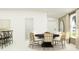 Bright dining area featuring a modern table with unique chairs and ample natural light at 7754 Painted Sky Pl, Land O Lakes, FL 34637