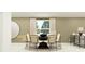 Elegant dining room with a large table, stylish chairs, and a contemporary light fixture at 7754 Painted Sky Pl, Land O Lakes, FL 34637