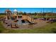 Community playground featuring multiple play structures, swings, and seating areas for Gathering fun at 7754 Painted Sky Pl, Land O Lakes, FL 34637