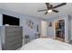Bedroom with ceiling fan, cozy bed, wall art and walk in closet at 8007 Bally Money Rd, Tampa, FL 33610