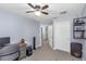 Bedroom with view into the hall, ceiling fan, and a wall with storage shelving at 8007 Bally Money Rd, Tampa, FL 33610