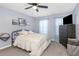 Bright bedroom with ceiling fan, cozy bed, and decorative wall art at 8007 Bally Money Rd, Tampa, FL 33610