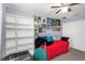 Bright bedroom with a ceiling fan, closet, and an eye-catching display of posters at 8007 Bally Money Rd, Tampa, FL 33610