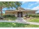 Community cabana featuring a gated entrance, well-maintained landscaping, and inviting exterior lighting at 8007 Bally Money Rd, Tampa, FL 33610