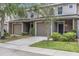Inviting townhome with a well-manicured lawn, attached garage, and neutral exterior paint at 8007 Bally Money Rd, Tampa, FL 33610