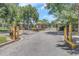 Gated community entrance with stone pillars and security features at 8007 Bally Money Rd, Tampa, FL 33610