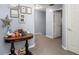 Hallway area with a small decorative table, framed photos, and access to the bedrooms at 8007 Bally Money Rd, Tampa, FL 33610