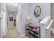 Light-filled hallway with a shoe rack, tiled floors, and artwork on the walls at 8007 Bally Money Rd, Tampa, FL 33610