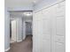 Hallway with neutral color scheme and storage cabinets leading to multiple rooms at 8007 Bally Money Rd, Tampa, FL 33610