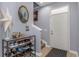 Light-filled hallway with a white door, tiled floors, and a shoe rack near the stairs at 8007 Bally Money Rd, Tampa, FL 33610