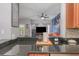 Modern kitchen featuring black countertops and an open view into the living room area at 8007 Bally Money Rd, Tampa, FL 33610