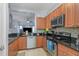 Well-equipped kitchen featuring stainless steel appliances, granite countertops, and wooden cabinetry at 8007 Bally Money Rd, Tampa, FL 33610