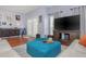 Bright living room featuring modern decor, hardwood floors, and a large flat screen TV at 8007 Bally Money Rd, Tampa, FL 33610