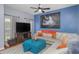 Bright living room featuring a sectional couch, blue accent wall and wood floors at 8007 Bally Money Rd, Tampa, FL 33610