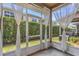 Screened patio overlooking a lawn with tall hedges, providing plenty of privacy at 8007 Bally Money Rd, Tampa, FL 33610