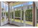 Relaxing screened patio with sheer curtains and views of the green backyard at 8007 Bally Money Rd, Tampa, FL 33610