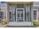 View of the screened-in patio with sheer curtains and exterior access at 8007 Bally Money Rd, Tampa, FL 33610