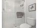 Shower with glass door, and stylish tile, accompanied with an elongated toilet at 8007 Bally Money Rd, Tampa, FL 33610