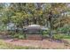 Community sign for Townhomes at Wexford set amongst mature trees and landscaping at 8007 Bally Money Rd, Tampa, FL 33610
